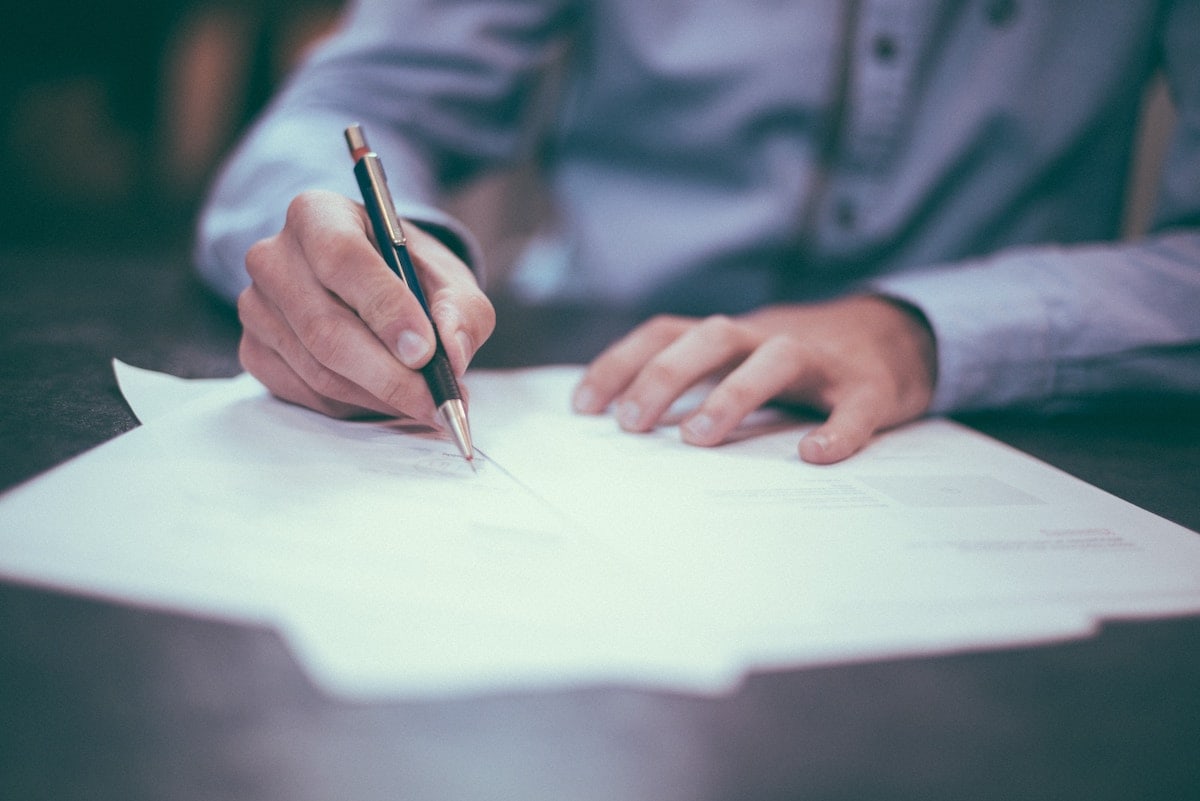 A man signing papers